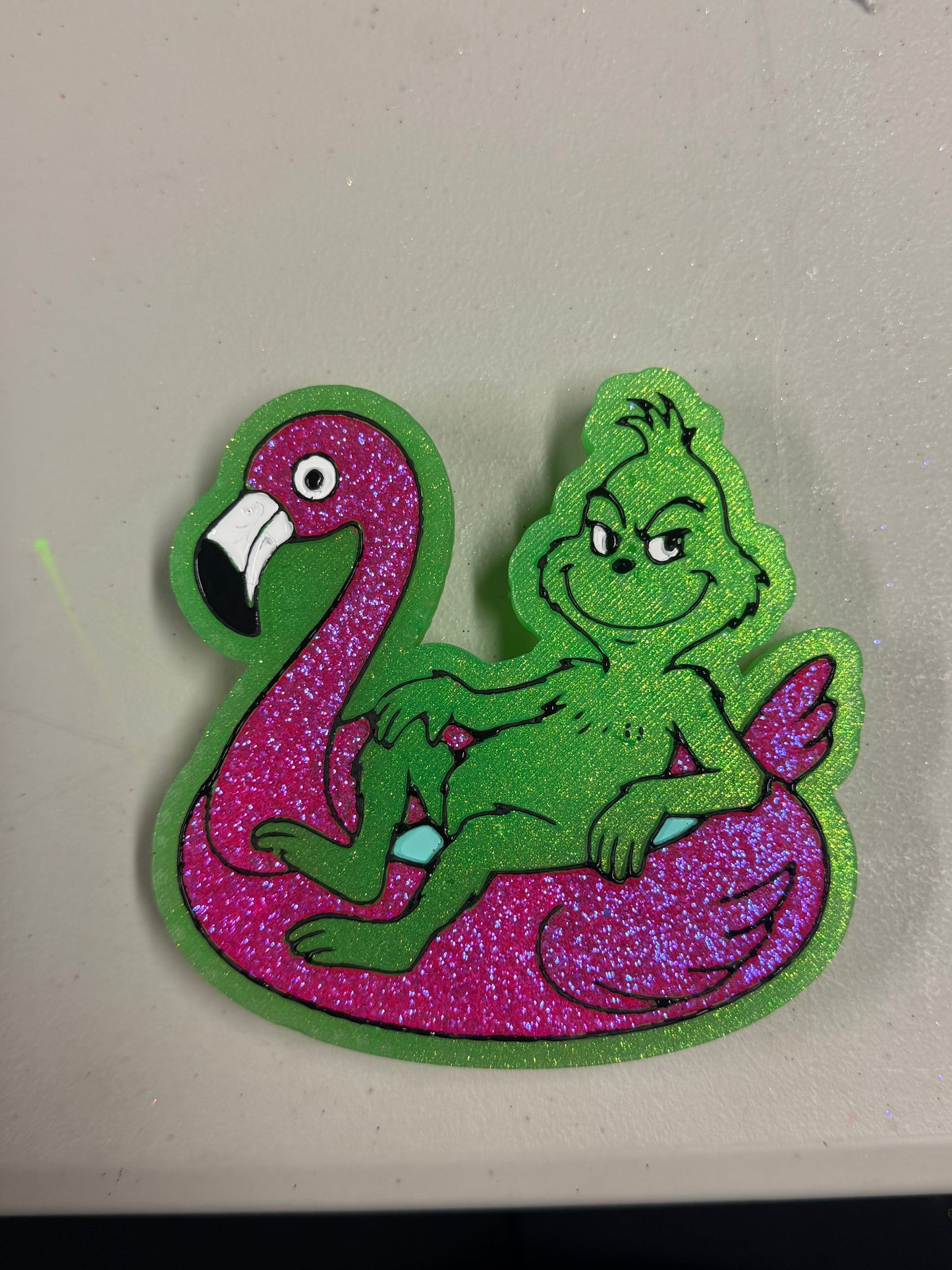 Grinch on flamingo float